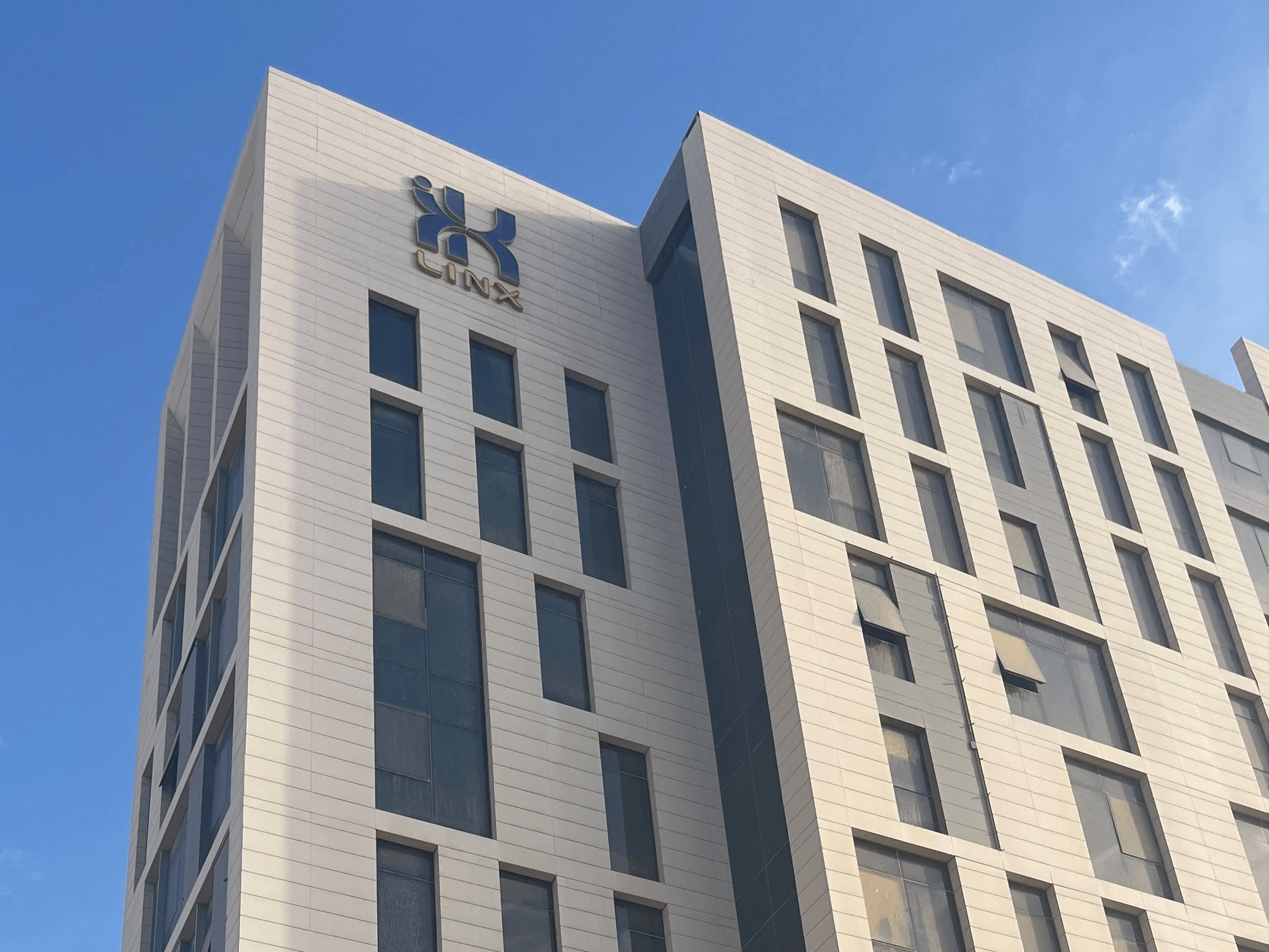 LINX Tower corner façade with the original navy emblem and gold LINX lettering